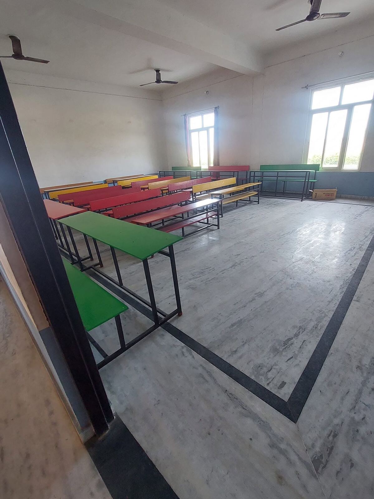 Another classroom with benches and fans