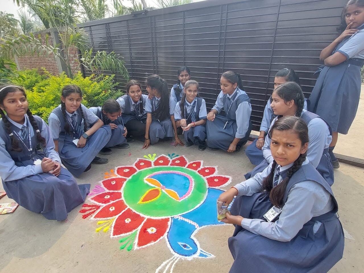 Students with rangoli art during Diwali celebration